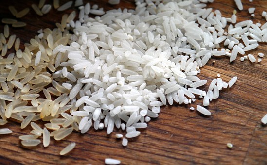 A close up of grains of rice scattered on the counter.