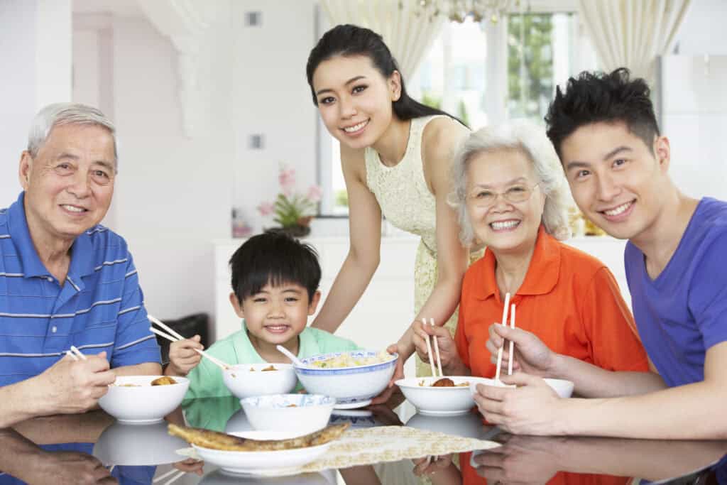 Portrait Of Multi-Generation Chinese Family Eating Meal Together
